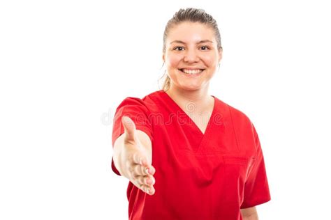 Young Medical Nurse Wearing Red Scrub Offering Handshake Gesture Stock