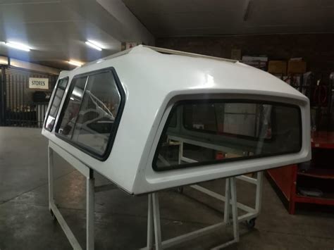 We supply canopies locally in the western cape region and automobile spare parts. NP300 LWB half door high line SA Canopy - Auto Enhance
