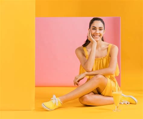 Free Photo Woman In Yellow Dress Sitting On The Floor