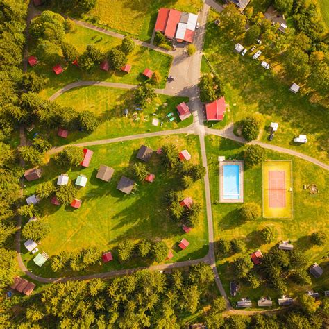Aerial view of summer camp. Cabins, caravans, swimming pool, tennis