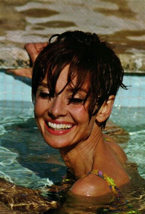 A Woman Smiles While Swimming In The Pool