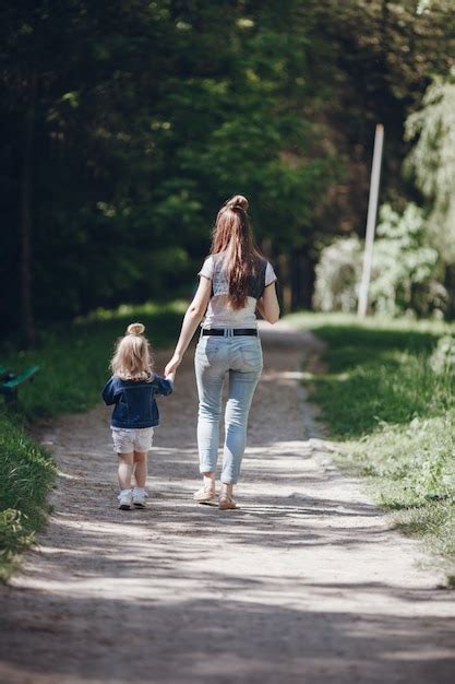 Free Photo Mother And Daughter Walking On A Dirt Road
