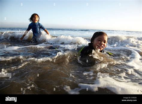Mixed Race Boys Swimming In Ocean Stock Photo Alamy