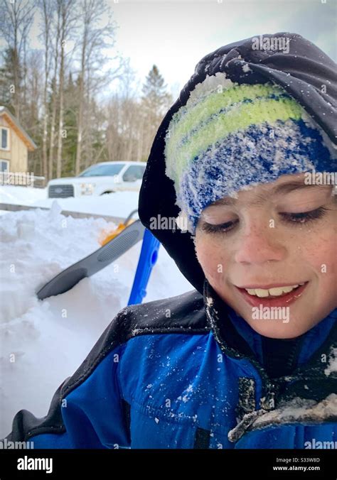 A Smiling Ten Year Old Boy With Red Cheeks From Playing In The Snow