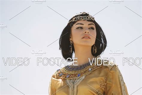 Beautiful Woman With Fashion Make Up And Hairstyle Like Egyptian Queen Cleopatra Outdoors