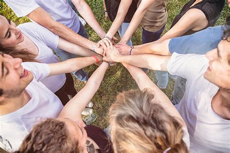 Team Of Competitors In Circle With Hands In Huddle Stock Photos