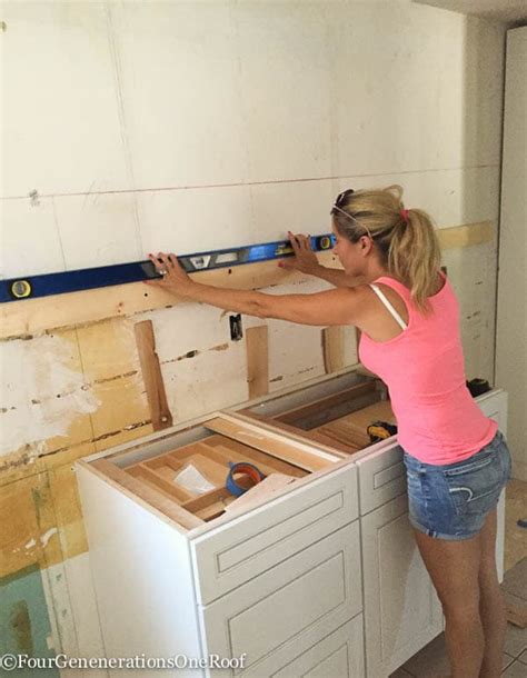 This way, the base cabinets are not in your way during the necessary lifting and fastening. Our kitchen Renovation Series {installing new cabinets ...