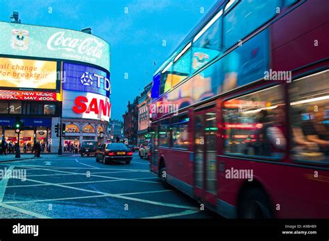Bus And Piccadilly Circus Nightlife Reflections In West End Of London
