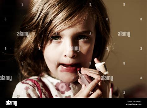 Little Girl Putting Lipstick On Hi Res Stock Photography And Images Alamy
