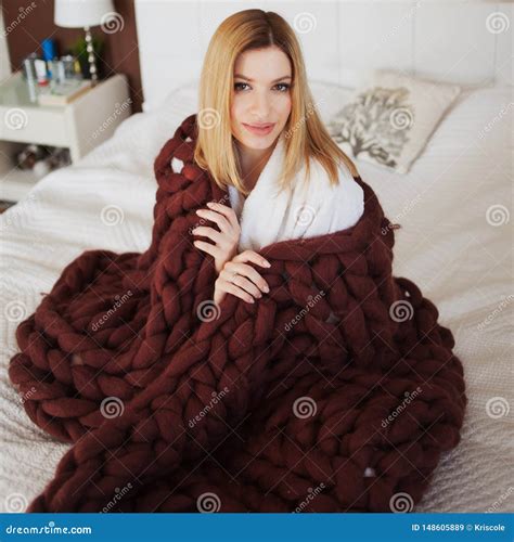 An Attractive Young Woman Is Wrapped In A Soft Fluffy Blanket Stock