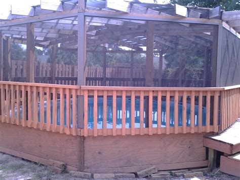 A Large Wooden Deck With A Pool In The Middle And A Gazebo Above It