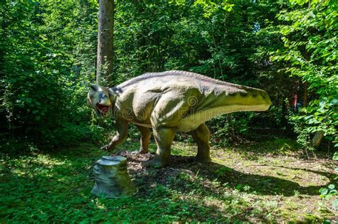 Artificial Dinosaurs And Ancient Reptile Sculptures In The Park Stock