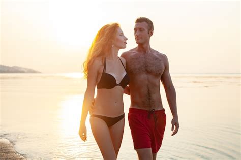 jovem casal sexy e romântico apaixonado feliz na praia de verão juntos se divertindo usando
