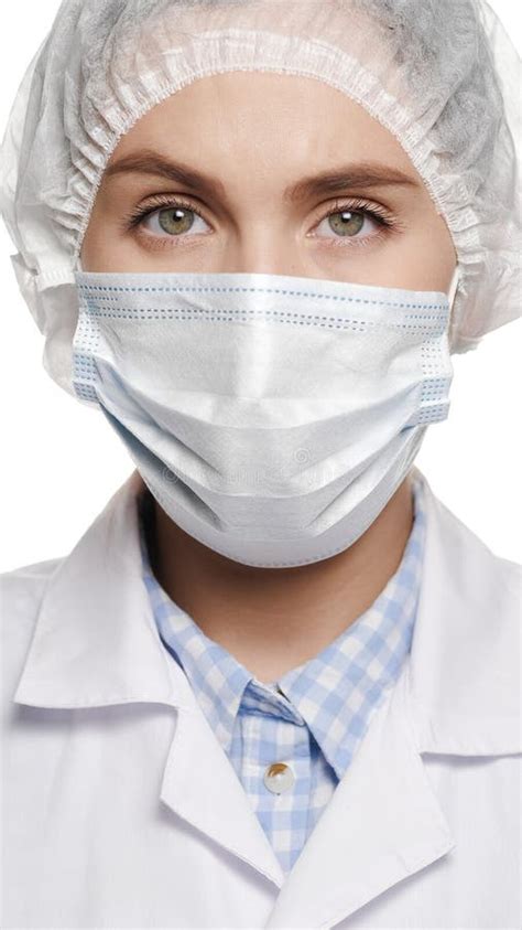 Close Up Of Concentrated Woman Doctor In Surgical Mask Is Looking At