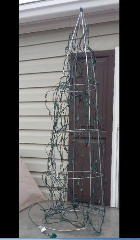 A Woman Wraps String Lights Around A Tomato Cage—look At Her Incredible
