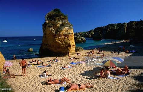 Sunbathers On Beach Lagos Portugal High Res Stock Photo Getty Images