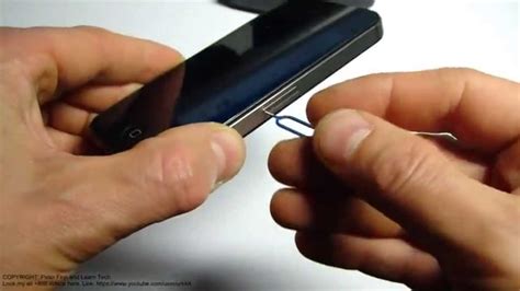 You won't be able to do with your thumb, you'll need some kind of tool. How to replace SIM card Apple iPhone 4S - YouTube