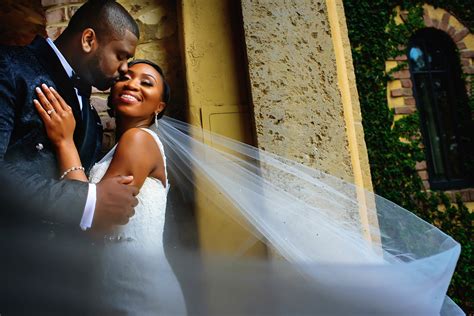 Groom Kisses Bride In Swirling Veil Photo By Alakija Studios