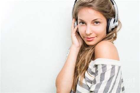 Smiley Young Brunette Listening To Music With Headphones Photograph By