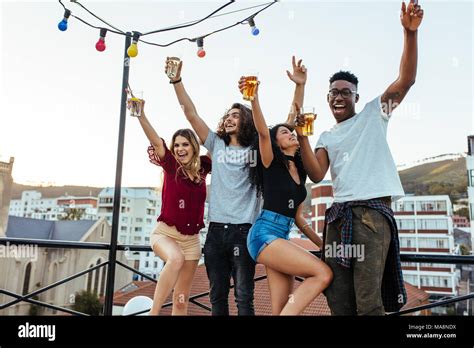 Friends Enjoying And Having Fun At Rooftop Multiracial Men And Woman Having Party On Rooftop In