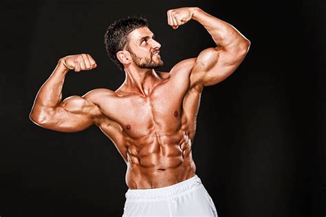 A Muscular Shirtless Man Flexing His Bicep Hoodoo Wallpaper