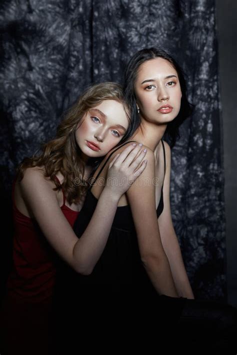 Beauty Spring Portrait Of Two Girls On A Dark Background Women Hug And Pose Beautiful Makeup