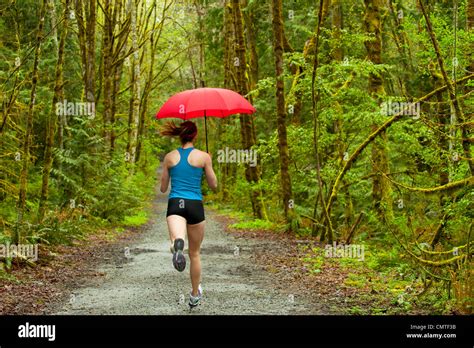 Woman With Umbrella On Country Road Hi Res Stock Photography And Images
