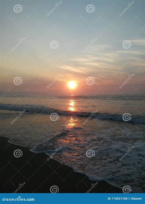 Sunrise At Seashore With Orange Clouds And Waves Stock Photo Image Of