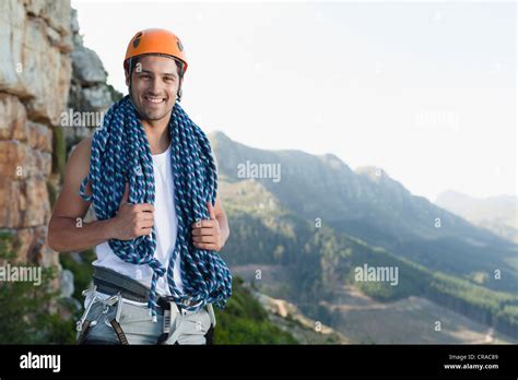 Climber Holding Coiled Rope On Mountain Stock Photo Alamy