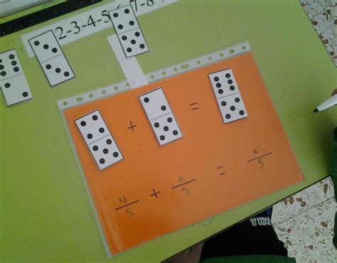 A Person Holding Up A Board With Dices On It