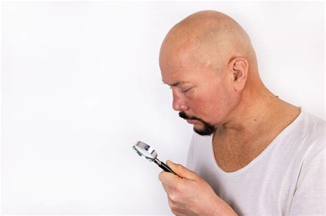 Premium Photo A Man Holds A Magnifying Glass In His Hands