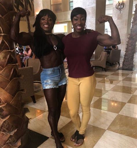 Two Women Standing Next To Each Other In Front Of A Palm Tree At A Hotel