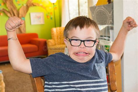 Boy With Downs Syndrome Flexing His Muscles Stock Photo Image Of