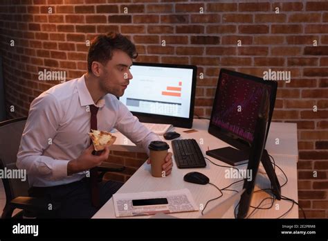 Forex Businessman Eating Pizza With Takeaway Coffee While Checking