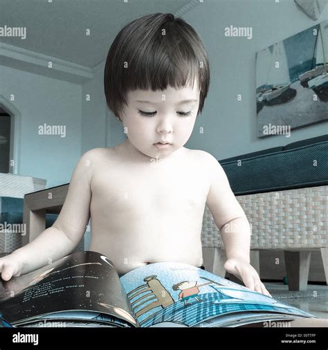 A Little Boy Reading A Book Stock Photo Alamy