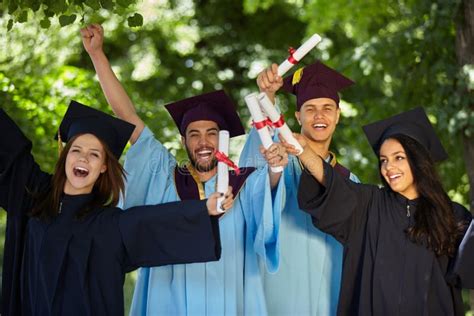 Students Wearing Graduation Gowns And Caps Stock Photo Image Of