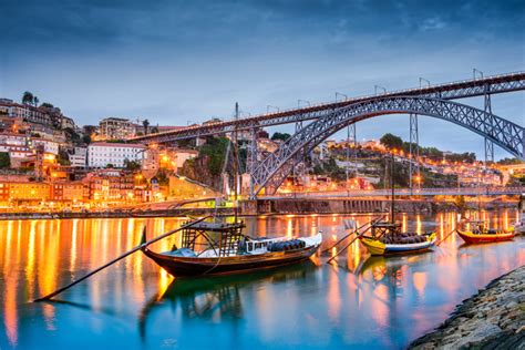 Porto Portugal Old Town Skyline On The Douro River With Rabelo Boats