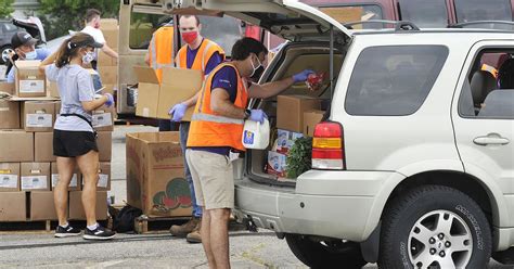 Volunteers will place food in your trunk. Mass food distribution today at Welcome Stadium