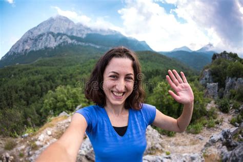 A Man Takes A Selfie Against The Backdrop Of A Beautiful Mountain