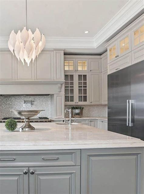 Cream gray cabinets with marble countertops & tile backsplash