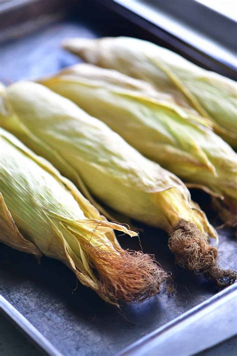 Set the foil wrapped corn directly on the oven rack and roast for 20 to 30 minutes. Oven Roasted Corn On The Cob With The Husks - The Gunny Sack