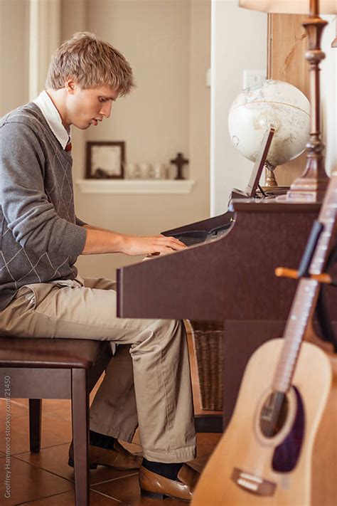 Teenager Playing Piano at Home by Geoffrey Hammond - Stocksy United