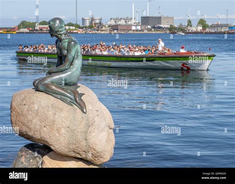 Tourists In Copenhagen Denmark Visiting The Bronze Sculpture Of The