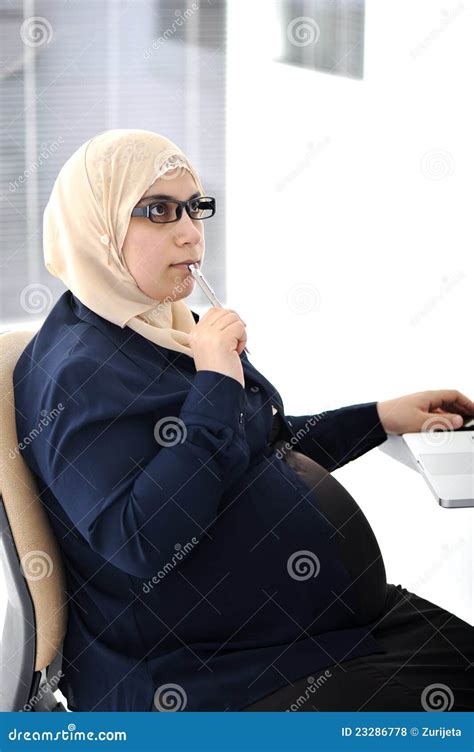 Pregnant Muslim Woman Embracing Her Belly Posing Over Grey Background