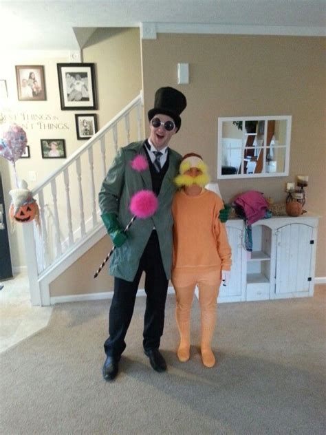 Two People In Costumes Standing Next To Each Other