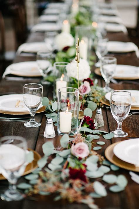 Reception Banquet Tables Lined With Candles Blush Roses And Greenery