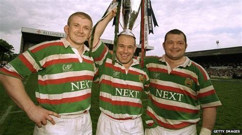 Three Rugby Players Are Holding Up The Trophy