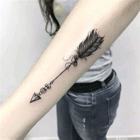 A Womans Arm With A Feather And Arrow Tattoo On The Left Inner Forearm
