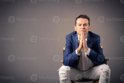 Portrait Of Pensive Businessman Sitting Against The Wall 11225552