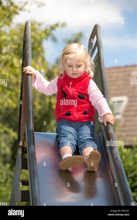 Little Girl On Slide Stock Photo Alamy